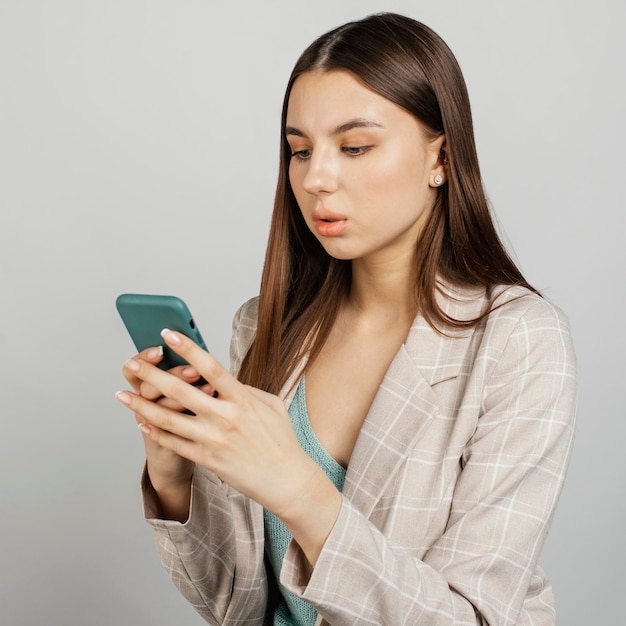 Gratis foto portret stijlvolle vrouw met behulp van mobiel