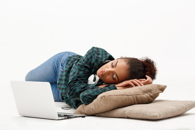 Portret van een jong Afrikaans meisje met laptop op een witte achtergrond