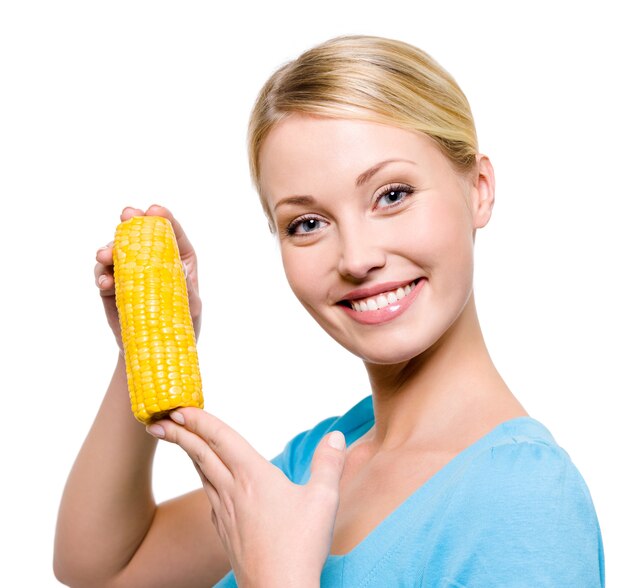Portret van een jonge mooie vrouw met rauwe maïs - geïsoleerd op wit
