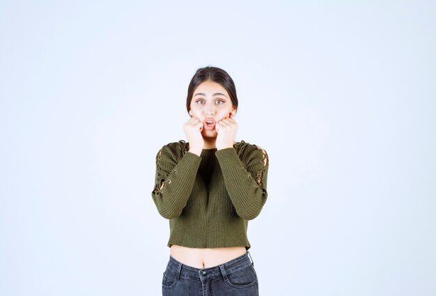 Portret van een jonge mooie vrouw model permanent en poseren over witte muur.