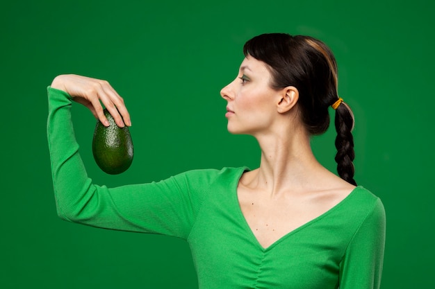 Portret van een jonge vrouw met avocado