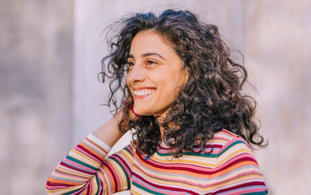 Portret van een lachende jonge vrouw in kleurrijke t-shirt