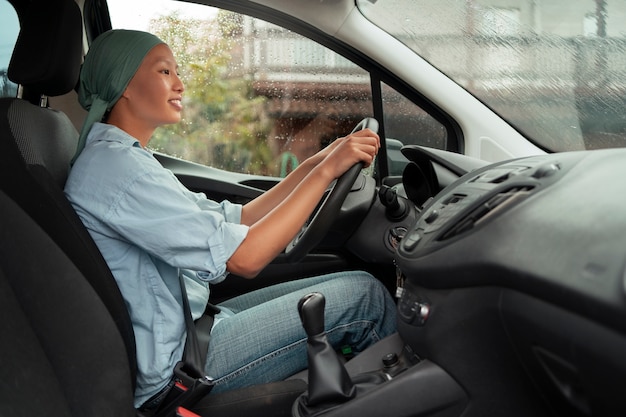 Portret van een vrouw met kanker die een auto bestuurt