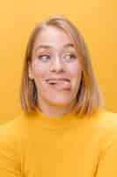 Gratis foto portret van een vrouw met verschillende gezichtsuitdrukkingen in een gele scène