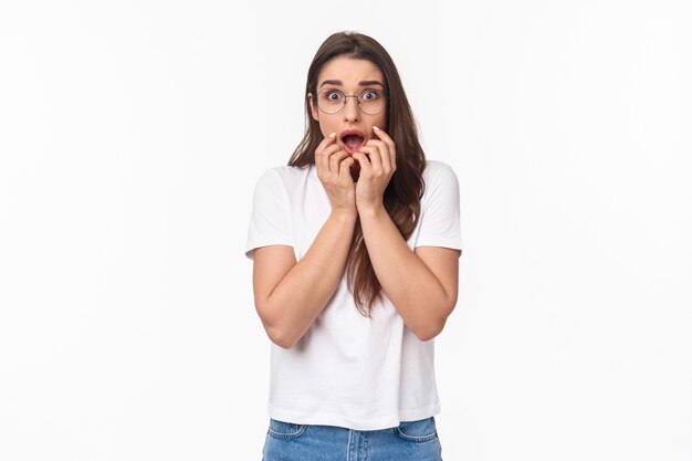 portret van geschokte, overweldigde en paniekerige jonge vrouw