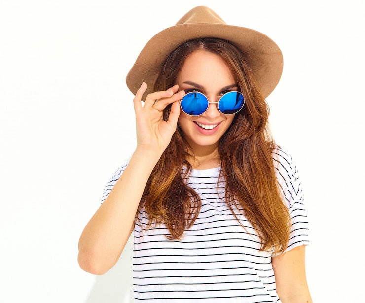 Gratis Foto portret van jong modieus lachend vrouwenmodel in toevallige de zomerkleren in bruine die hoed op witte muur wordt geïsoleerd