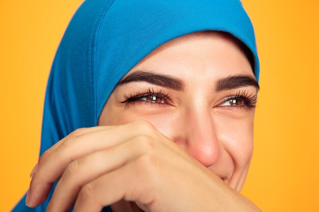 Portret van jonge moslimvrouw geïsoleerd op geel