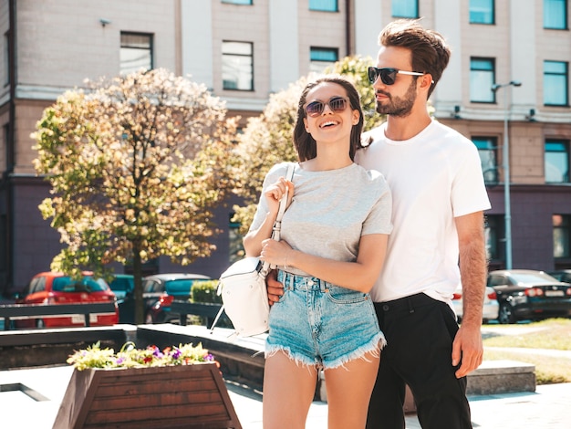 Portret van lachende mooie vrouw en haar knappe vriendje vrouw in casual zomerkleren gelukkige vrolijke familie vrouw plezier paar poseren op de straat achtergrond in zonnebril