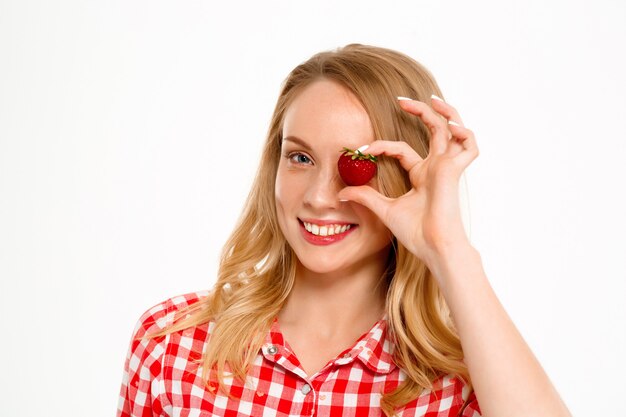 Portret van landvrouw met aardbei op wit.