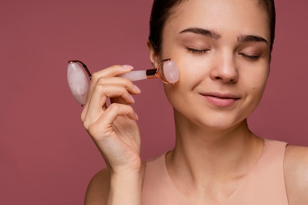 Portret van mooie vrouw met behulp van een jade roller