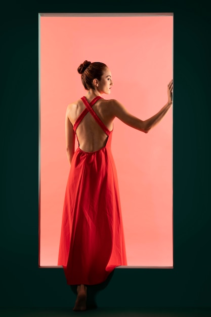 Portret van mooie vrouw poseren met een zwierige rode jurk