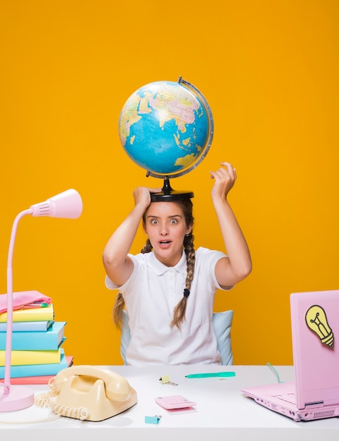 Portret van schoolmeisje met een wereldbol