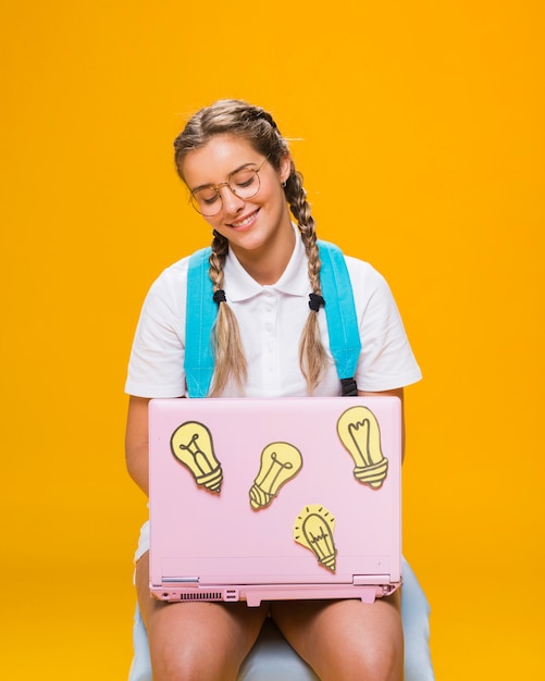 Portret van schoolmeisje op gele achtergrond