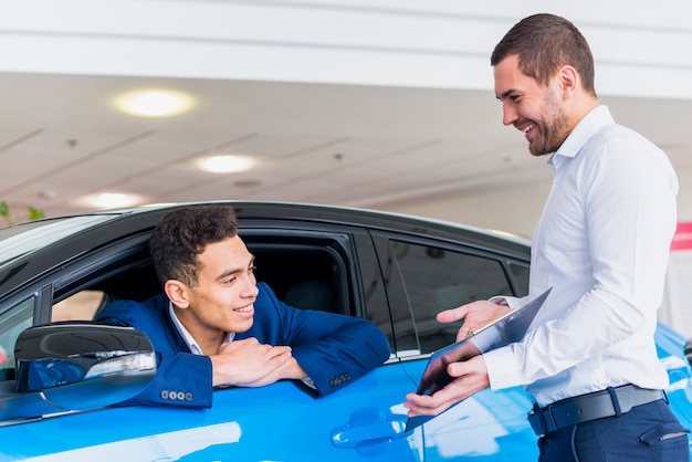 Gratis foto portret van verkoper in het autohandel drijven