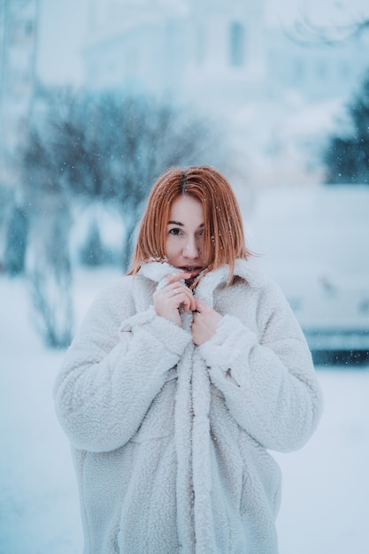 Portret vrouwelijk model buiten in eerste sneeuw
