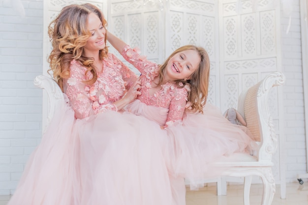 Prachtige moeder en dochter gekleed als prinsessen in dezelfde kleren pose