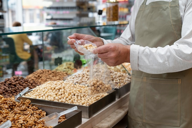 Gratis foto producent in zijn winkel met verschillende goodies