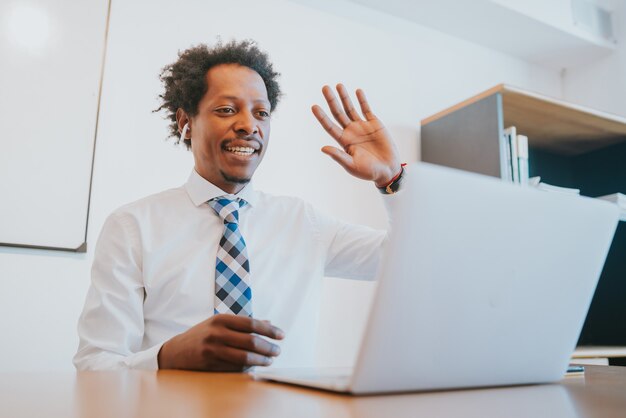 Professionele zakenman in een virtuele vergadering op videogesprek met laptop op kantoor. Bedrijfsconcept.