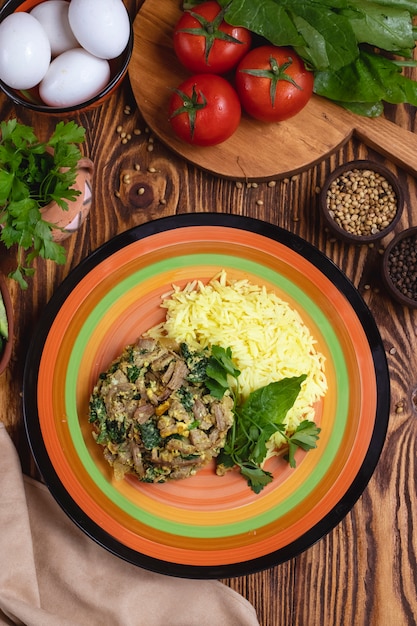 Gratis foto rijst met vlees spinazie eieren tomaat kruiden greens bovenaanzicht