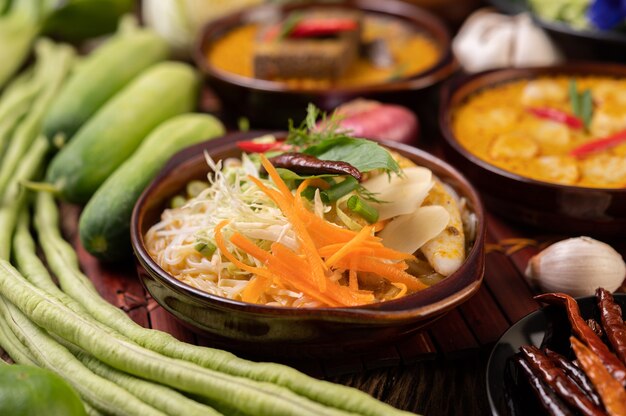 Rijstnoedels, rode curry met gehaktballetjes, met gedroogde pepers, basilicum, komkommer en kousenband