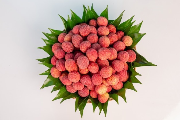 Gratis foto rode litchifruit die in een mand wordt geplaatst.