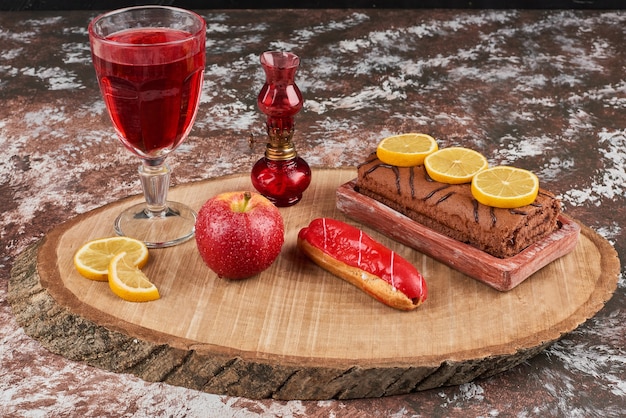Rollcake met een glas wijn op een houten bord.