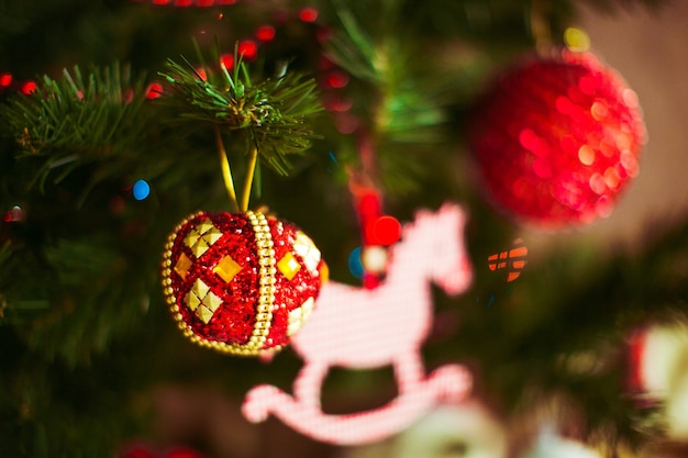 Rood speelgoed hangt aan een kerstboom