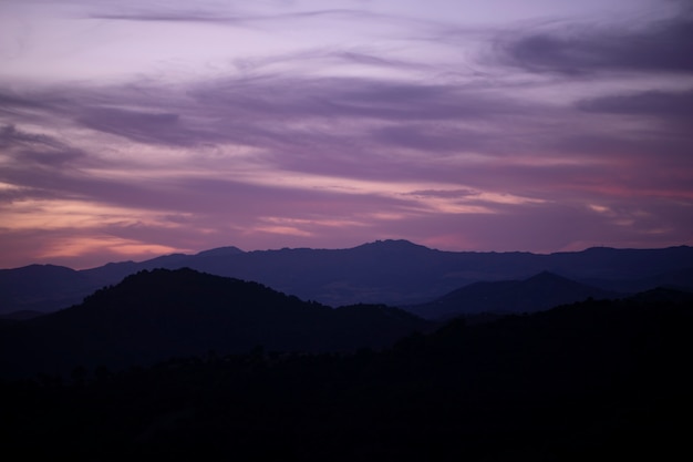 Gratis foto roze bewolkte hemel met bergen