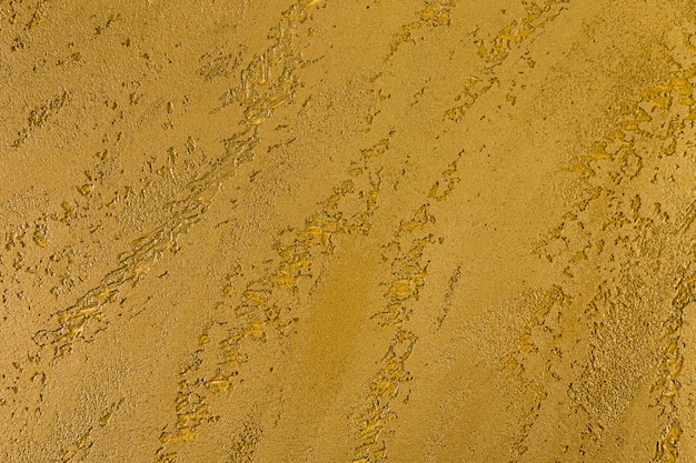 Ruw geel betonnen muuroppervlak