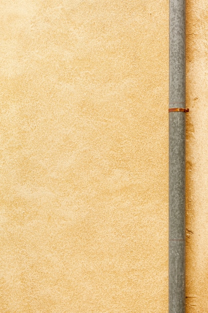 Gratis foto ruwe muuroppervlakte met pijp en roest