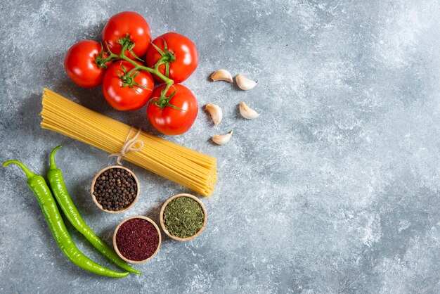 Ruwe spaghetti met groenten op een marmeren achtergrond.