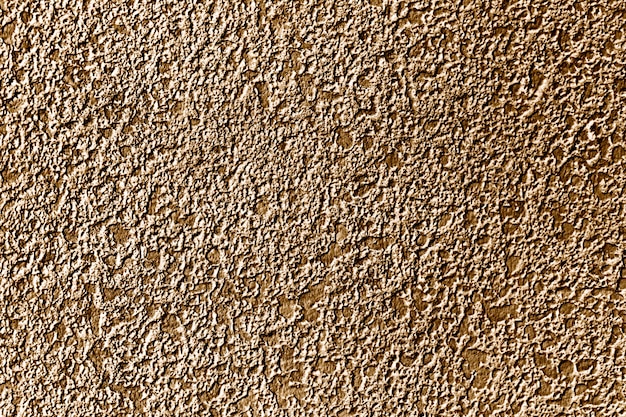 Ruwweg goud geschilderde betonnen muur oppervlak achtergrond