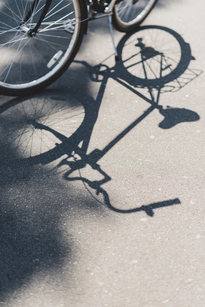 Gratis foto schaduw van fiets op de weg