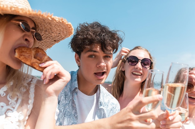 Seizoensgebonden feest in badplaats. Sluit de handen van vrienden die vieren, rusten, plezier hebben, rammelen