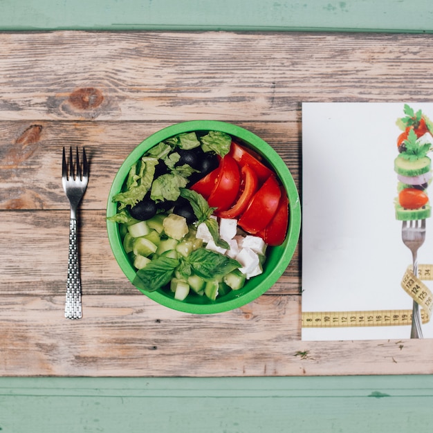 Seizoensgebonden groene groentesalade met kruiden en tomaat.