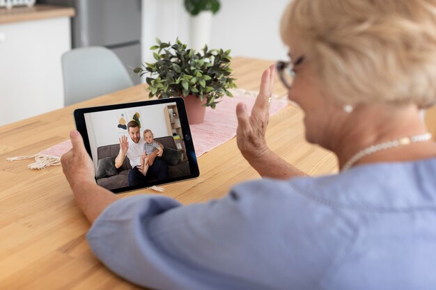 Senior vrouw die een videogesprek voert met haar familie