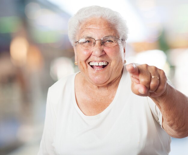 Senior vrouw te wijzen en lachen