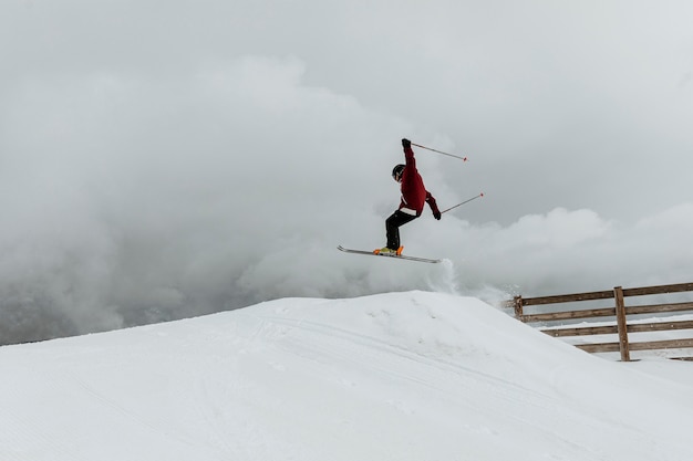 Gratis foto skiër springen over heuvel afstandsschot