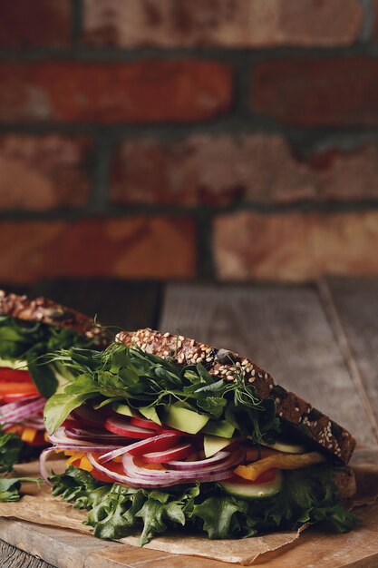 Smakelijke veganistische sandwich over houten tafel