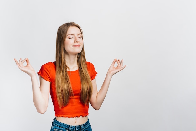 Gratis foto smileyvrouw die met exemplaarruimte mediteren