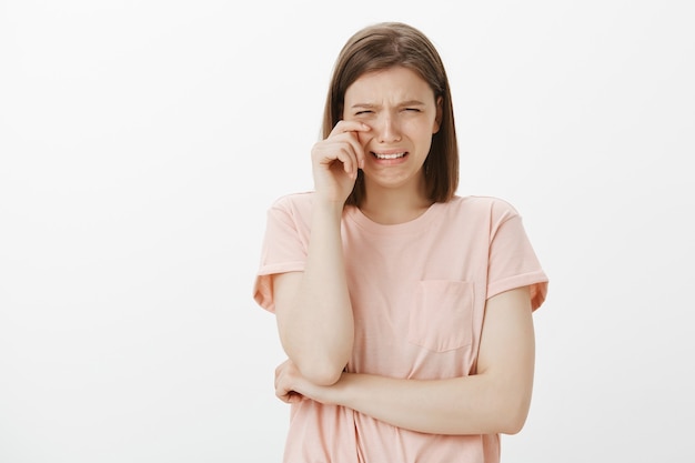 Snikkende en huilende vrouw die tranen afveegt met een zenuwinzinking, zich verdrietig voelt