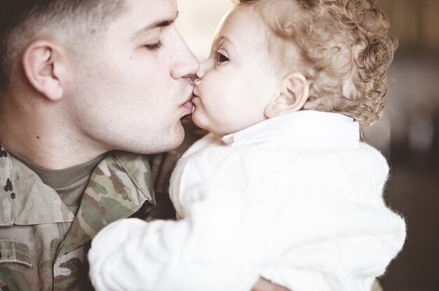 Soldaat vader kust zijn zoon op de lippen