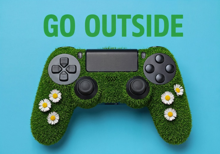 Gratis Foto spelcontroller met gras en madeliefjes