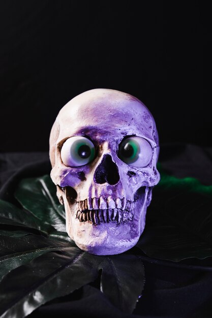 Spookachtige schedel met mooie oogbollen verlicht door paars licht