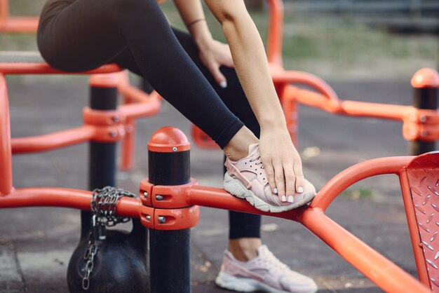 Sport meisje in een zwarte top training in een zomer park