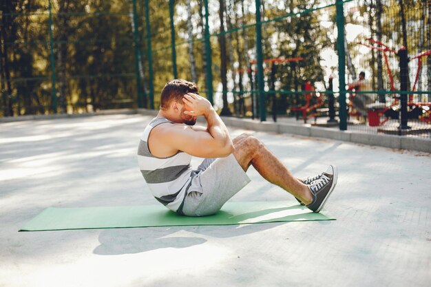 Sportman in een park van de ochtendzomer