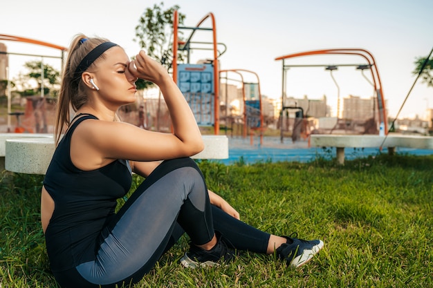 Gratis foto sportvrouw rusten en luisteren naar muziek