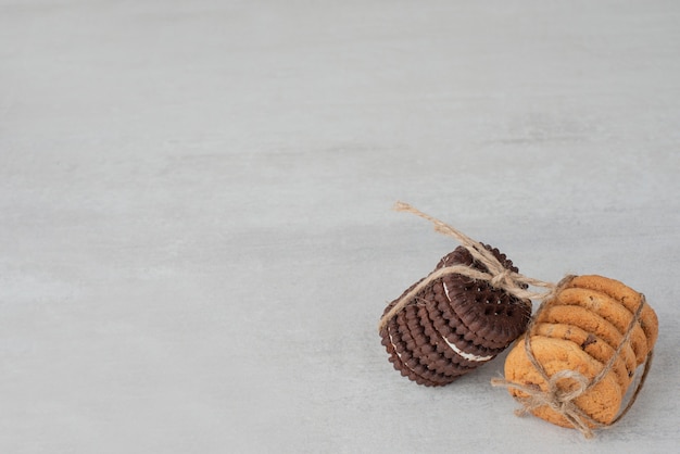 Stapel koekjes gebonden met touw op witte tafel.