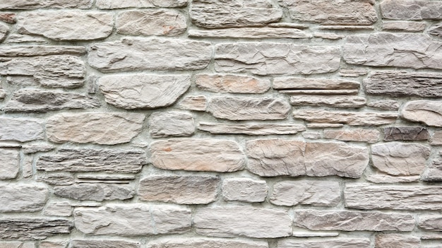 Stenen lichte muur textuur achtergrond als achtergrond of textuur. een deel van een stenen muur. ruimte kopiëren.