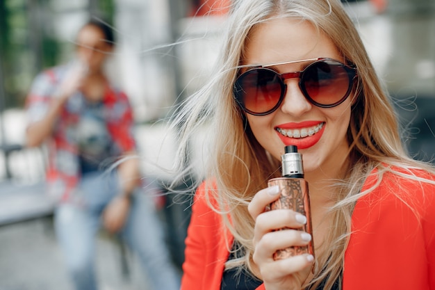 Stijlvolle jong koppel met vape in een stad